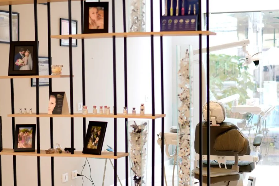 A modern multi-location dental clinic interior with display shelving