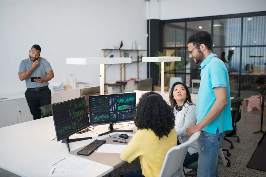 A B2B services team reviewing AI citation performance dashboards together