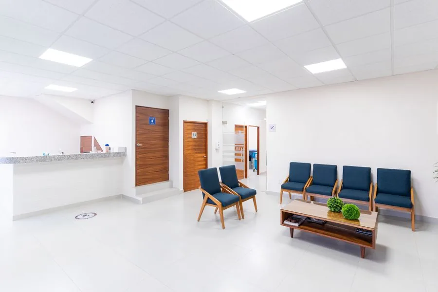 Bright, modern multi-location clinic waiting area with reception desk and seating