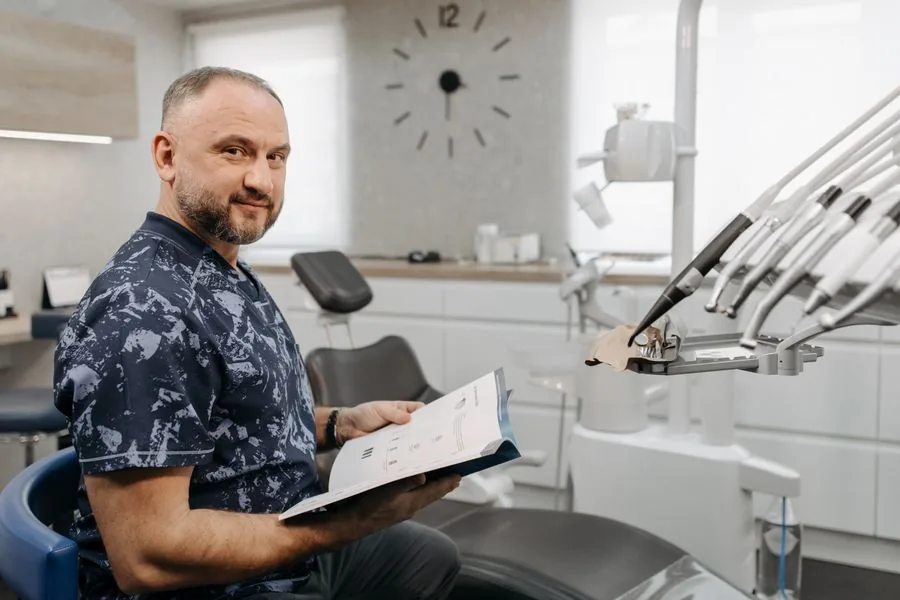 A dentist reviewing implant treatment materials with a patient in a modern clinic