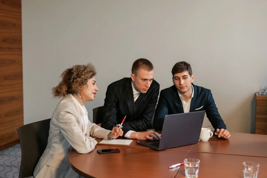 Consultants reviewing a proposal together at a meeting table