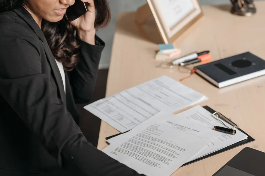 A lawyer taking a client call at her desk