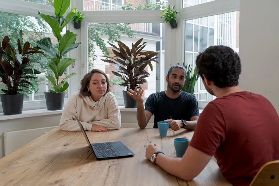 A SaaS team discussing product demo requests around a laptop