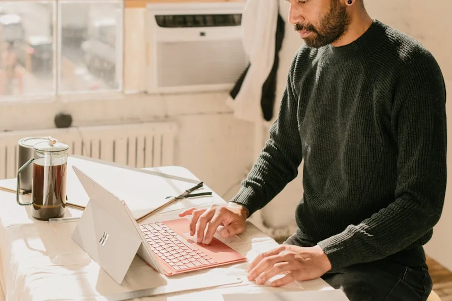 A service business owner working through campaign budget on a laptop