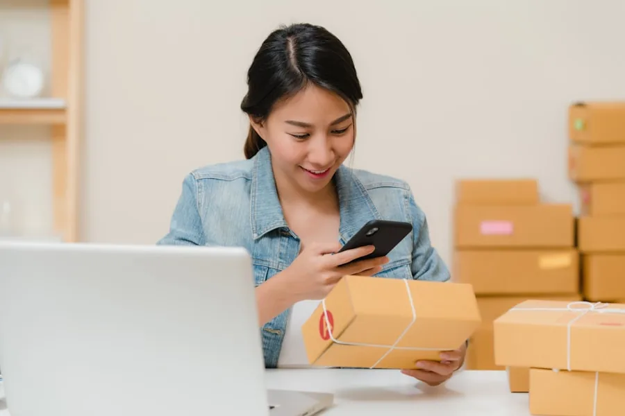 An e-commerce founder checking an order on her phone while packing parcels