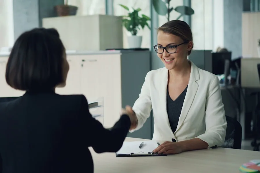 A professional services consultant closing a client meeting with a handshake